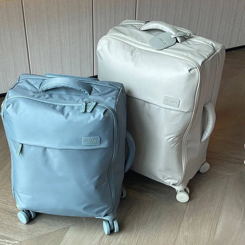 Ultra-light waterproof Oxford cloth suitcase with universal wheels in a bluestone green colour.