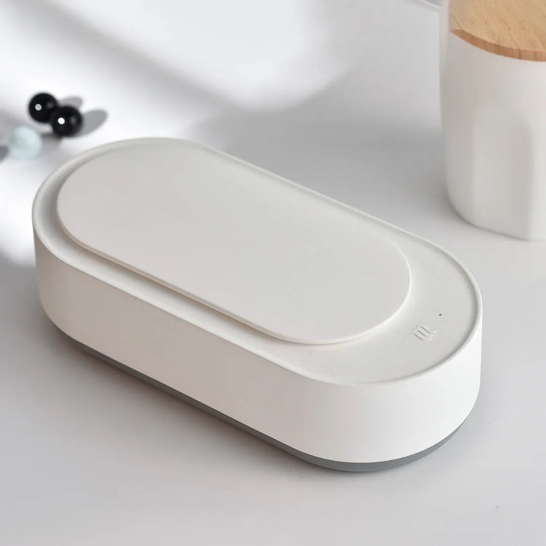 White portable ultrasonic cleaner machine with stainless steel tank for cleaning jewellery and glasses.