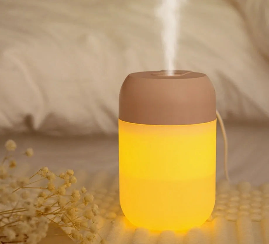 White cylindrical USB-powered mini humidifier with aromatherapy function on wooden desk