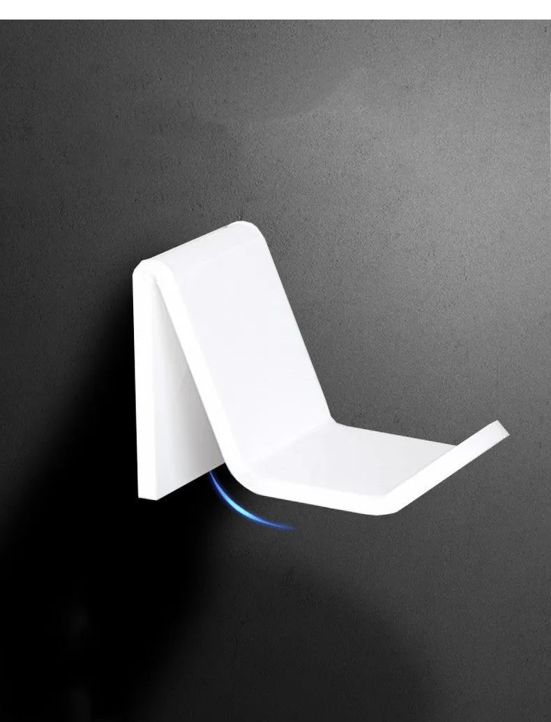 A universal plastic wall mount bracket for game controllers, shown in black, white, and transparent colour options.