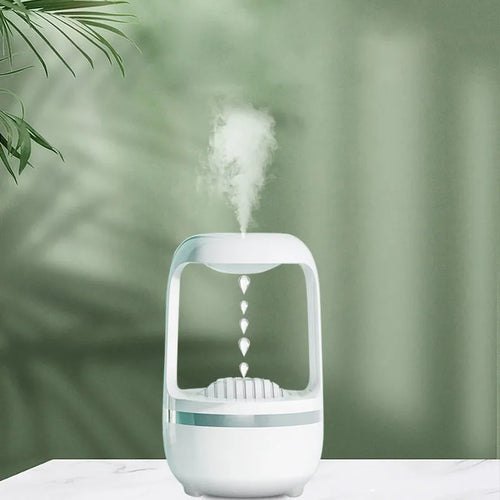 Black or white anti-gravity humidifier with water droplet effect on a desk.