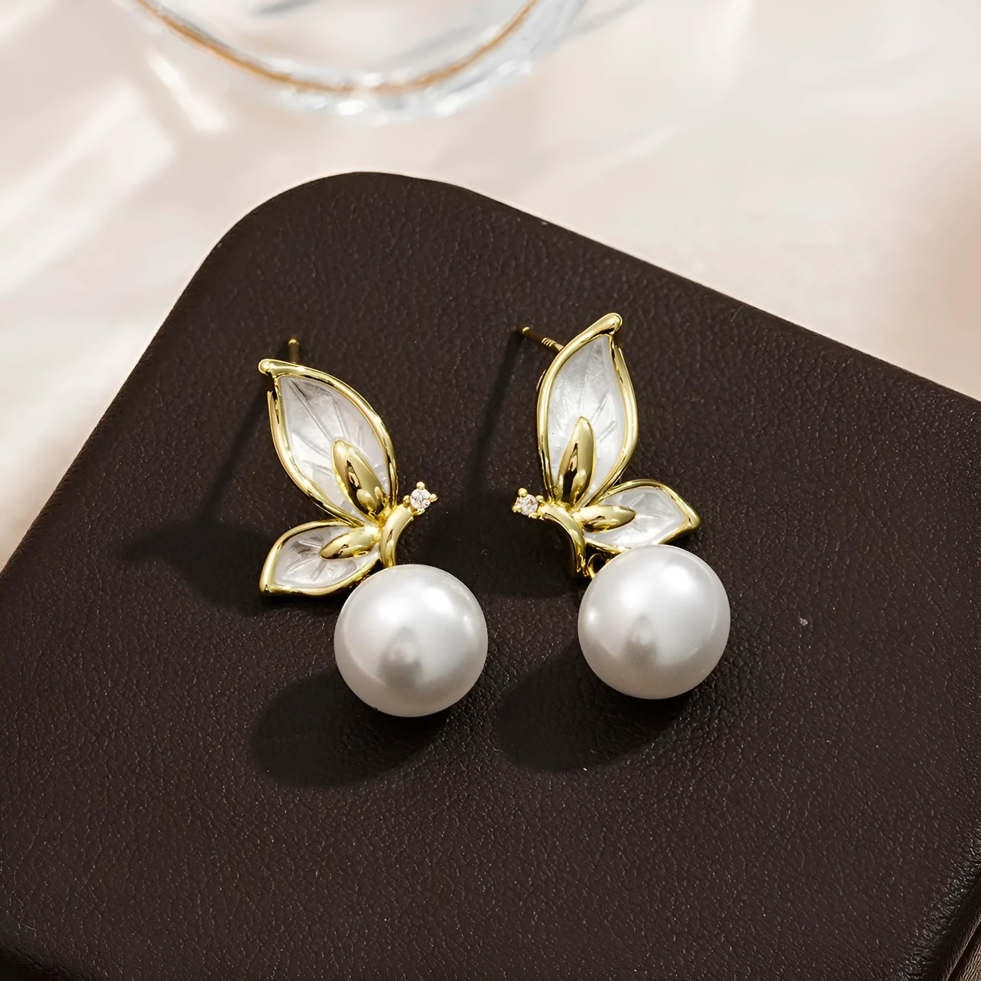 Gold-tone butterfly earrings with zircon painting detail on copper wings