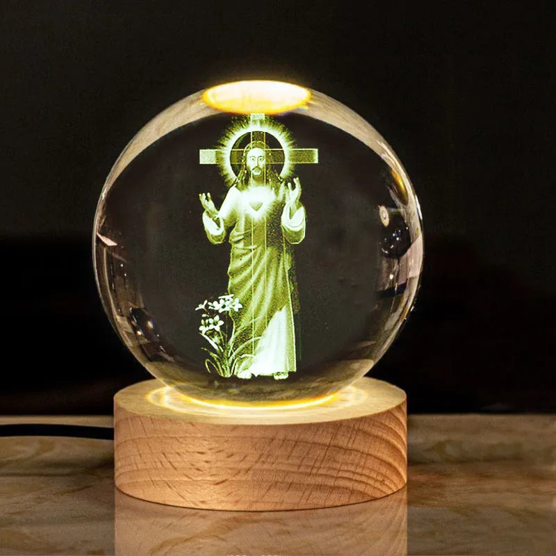 White crystal ball ornament with wood base and warm light, showing detailed internal design.