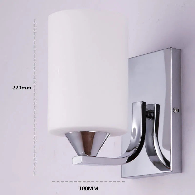 Modern chrome wall lamp with glass lampshade in single head configuration on white wall