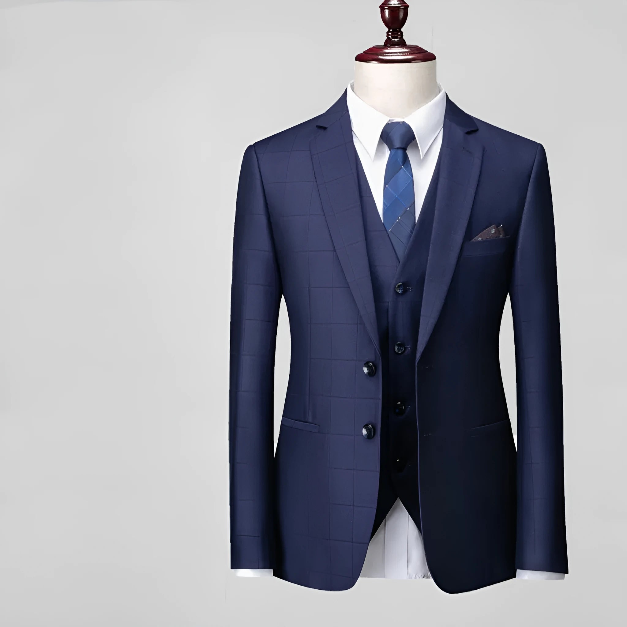 Men's navy blue slim fit three-piece plaid suit with jacket, vest, and trousers on a hanger.