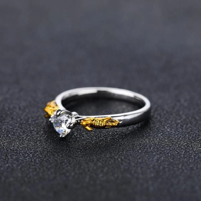 Copper crown modelling cosplay ring in a black gold finish on a hand.