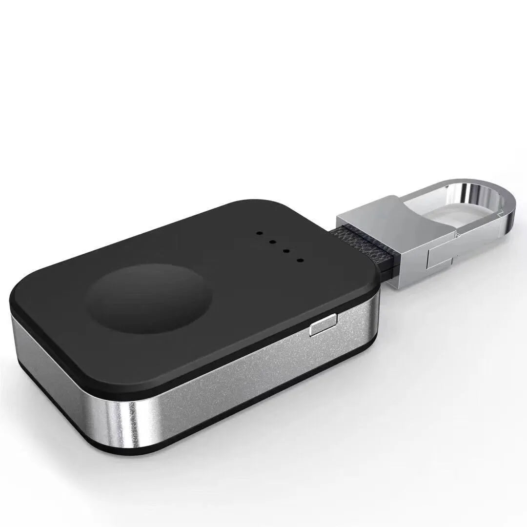 Black portable keychain power bank for wireless charging of Apple Watch on a white background.