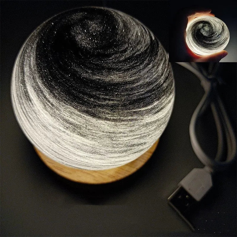 Compact modern planet USB night light on its base with dimmable three-colour lighting.