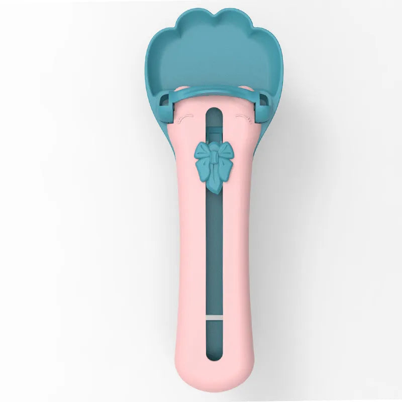 Green and pink pet feed spoon with silicone barrel for squeezing out sticky dog or cat food.