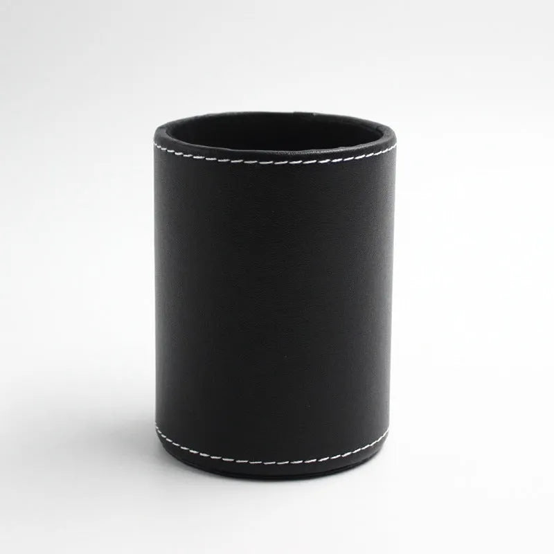 Round black leather pen container showing cylindrical shape and compact size for desk organisation.