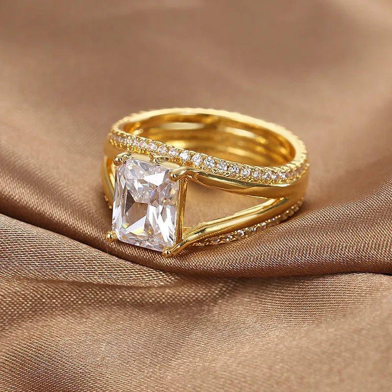 Gold geometric zircon ring for women on a plain background, showing its electroplated copper construction and minimalist design.