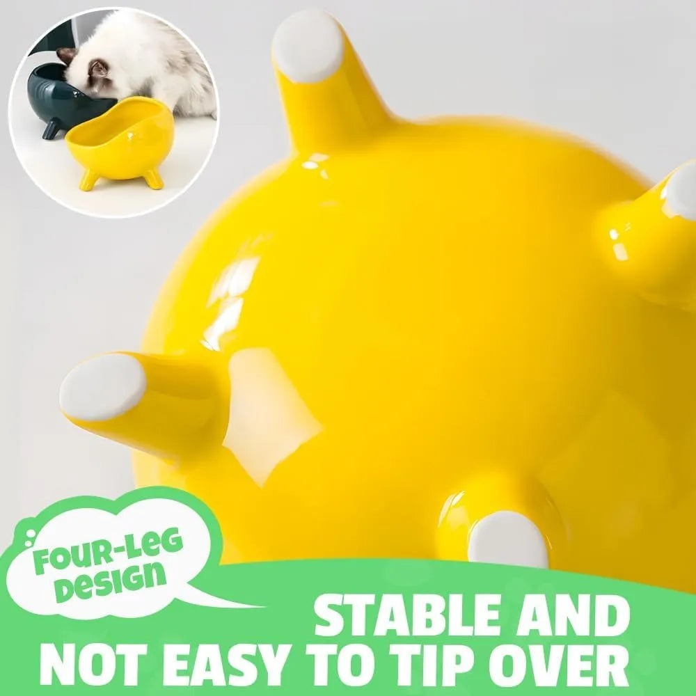 Green ceramic cat food bowl with four-leg stability base on wooden floor