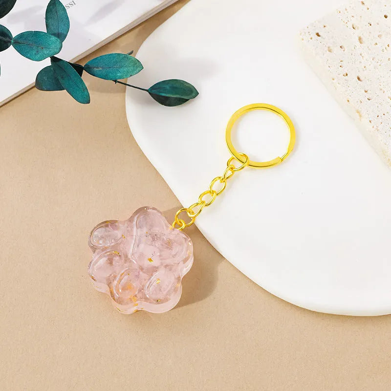 Natural crystal cat's paw keychain pendant in various gemstone colours including pink, red, blue, and green