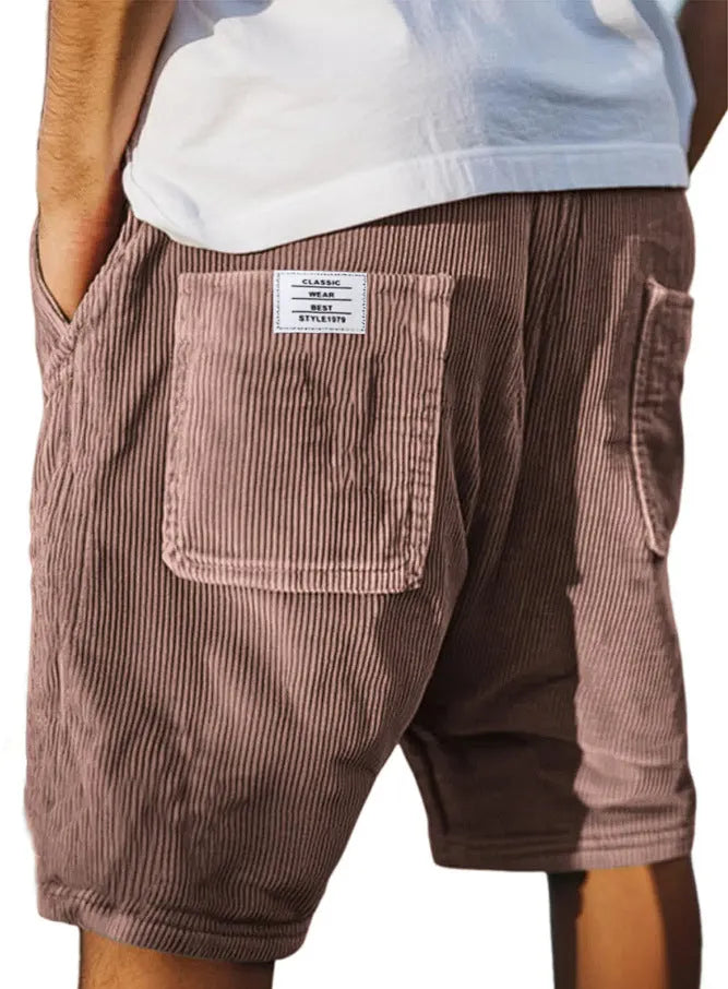 Men's grey corduroy shorts with multiple pockets and embroidery detail on leg, laid flat.