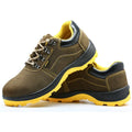 Bronze cow suede leather steel toe safety boots with non-slip sole on workplace surface