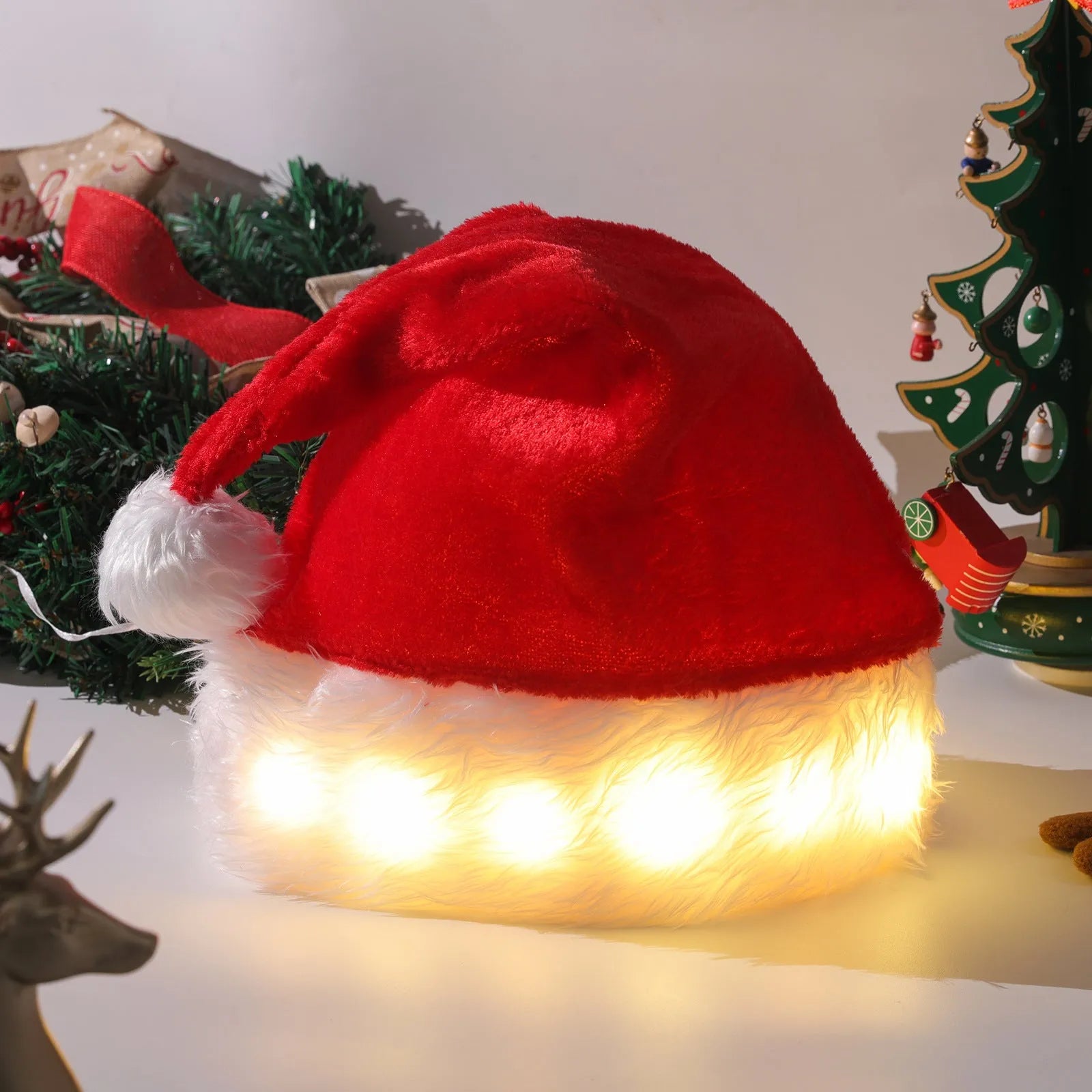 Red and white plush LED Santa hat with glowing coloured lights and a white pom-pom.
