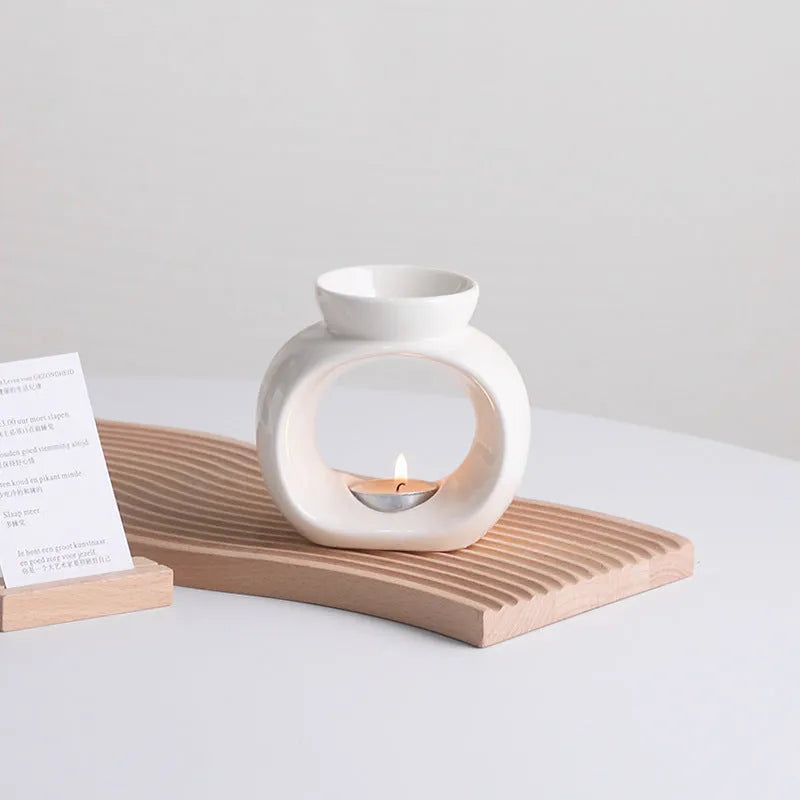 White Nordic style ceramic aromatherapy stove ornament on a table.