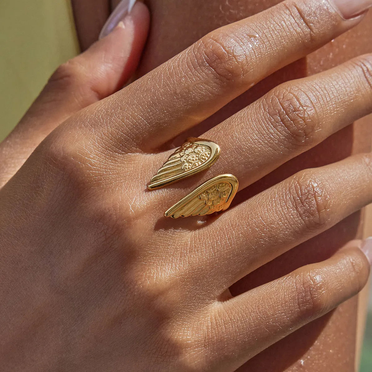 Stainless steel adjustable ring featuring a wings design with an electroplated finish.