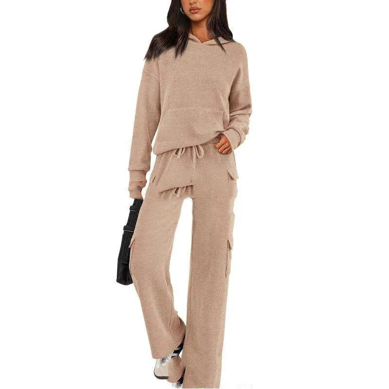 Women's two-piece polyester leisure suit in a solid colour, showing long sleeves and full-length trousers.