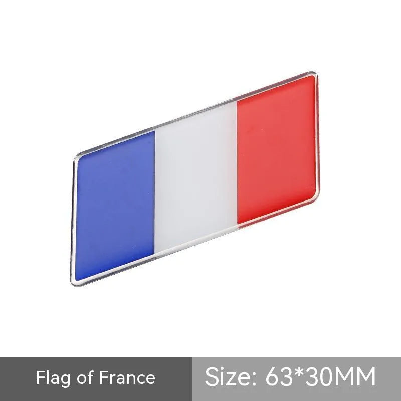 Aluminium metal car sticker with national flag design in a parallelogram shape.
