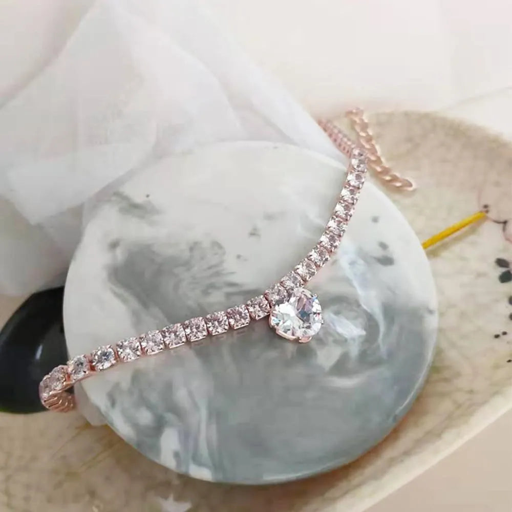 Gold heart-shaped rhinestone pet collar for dogs and cats with adjustable chain on a white background.