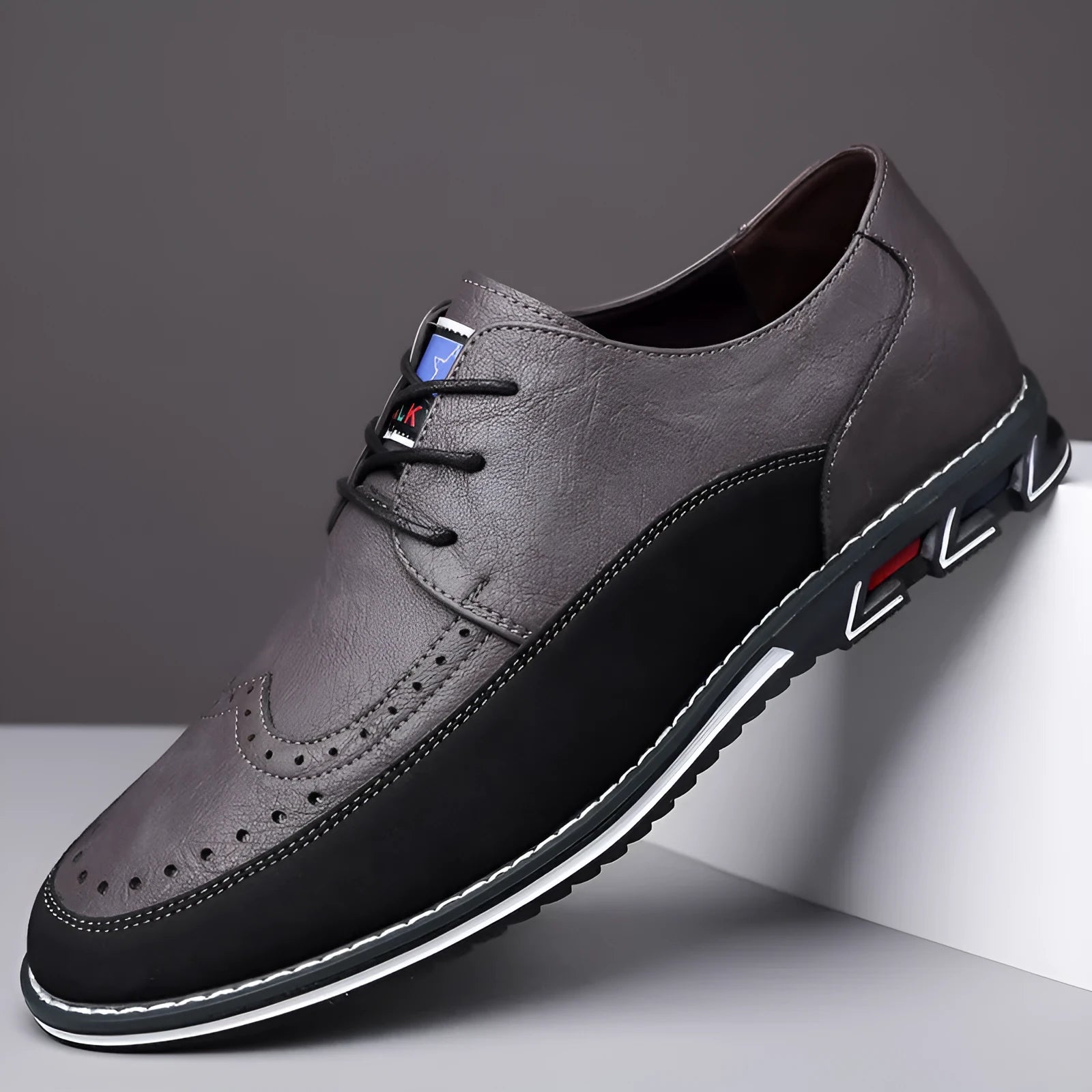 Men's leather slip-on shoes in black, grey, khaki and orange colours with rubber soles and low-top design