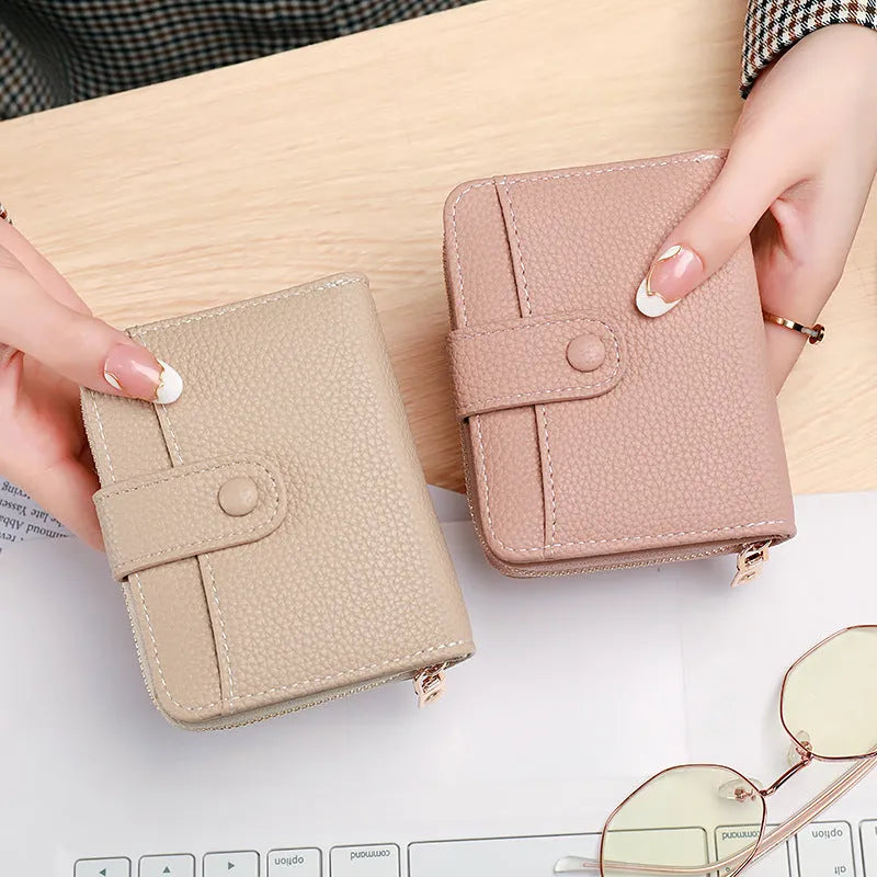 Ladies' short two-fold wallet in PU leather with a lychee pattern, shown in beige, pink, black, and red.
