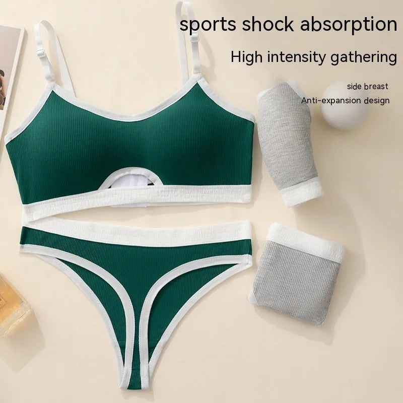White sports underwear vest with contrast back detail and matching underwear, shown on a hanger.