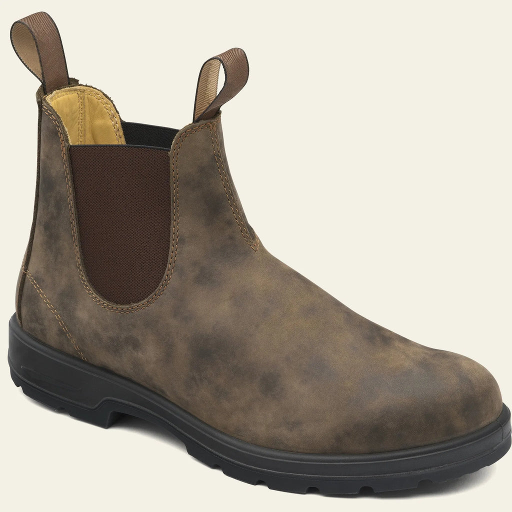 Vintage frosted brown leather Chelsea boot with round toe and low heel on a wooden surface.