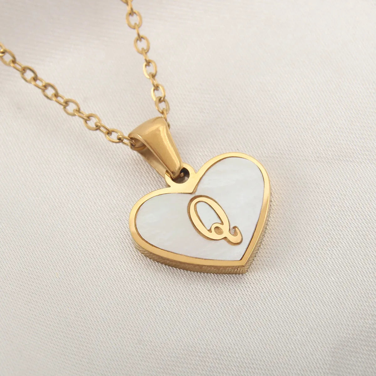 Gold plated heart-shaped personalised necklace with white shell charm on an adjustable chain.
