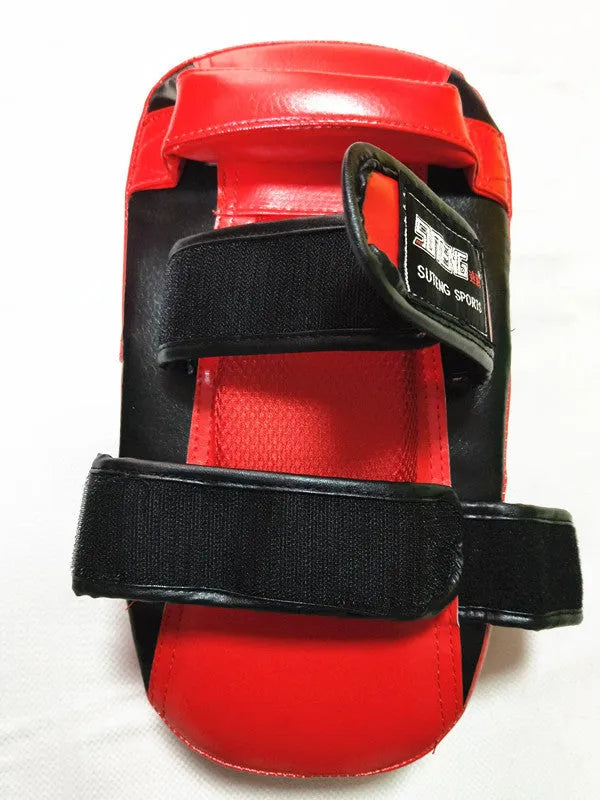 Black square boxing target pad with red trim and a double buckle strap on the back