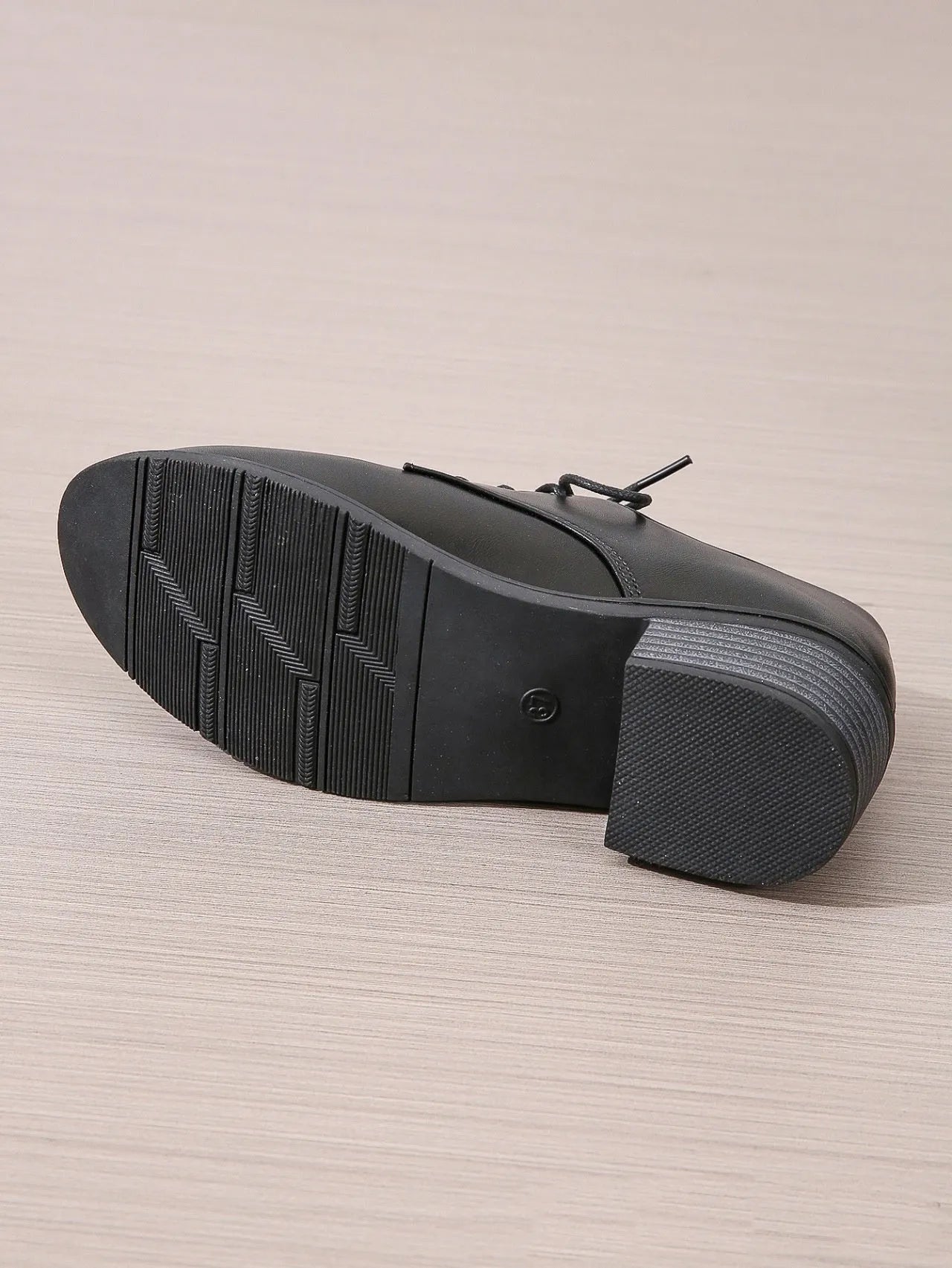 Black women's low-top work shoes with a chunky mid-heel and rounded toe.