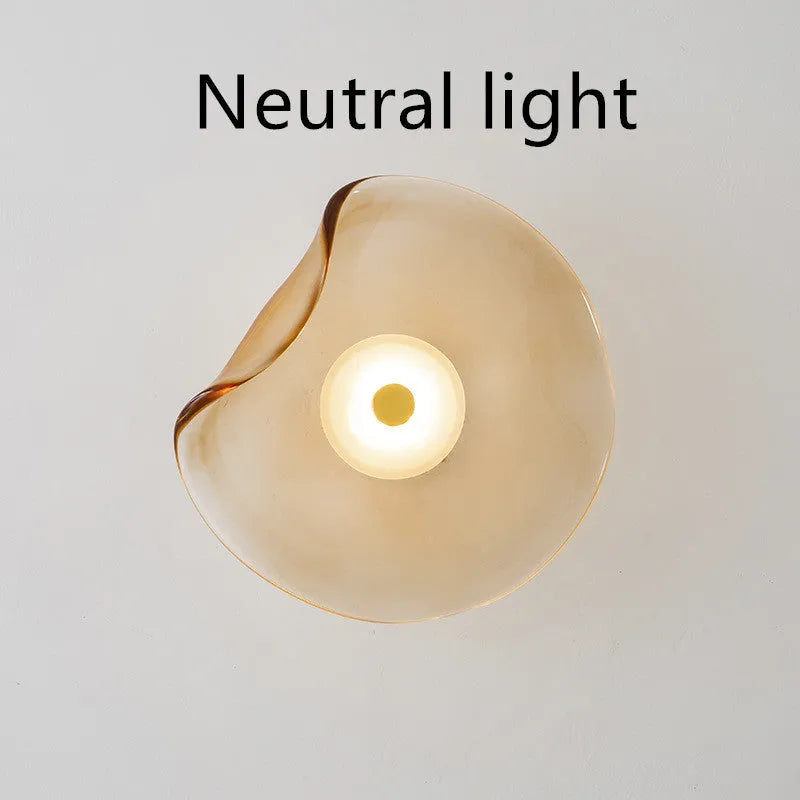 Round glass wall lamp for bedroom bedside in cognac, grey or light colour finishes.