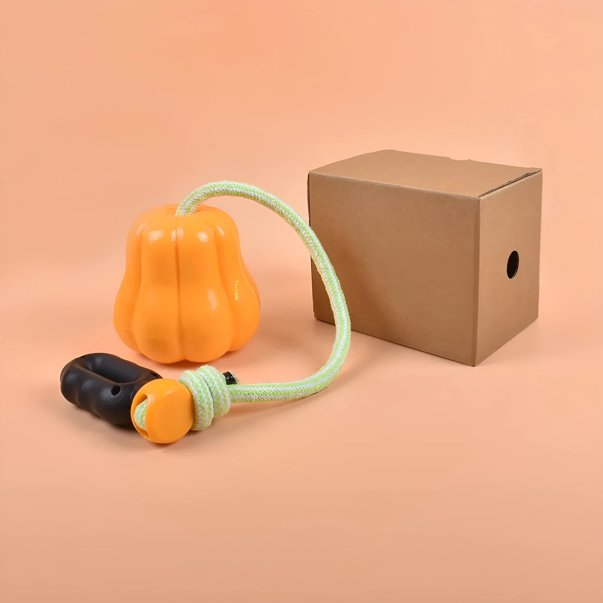 Plastic molar-shaped dog toy with rope attachment in pumpkin colour