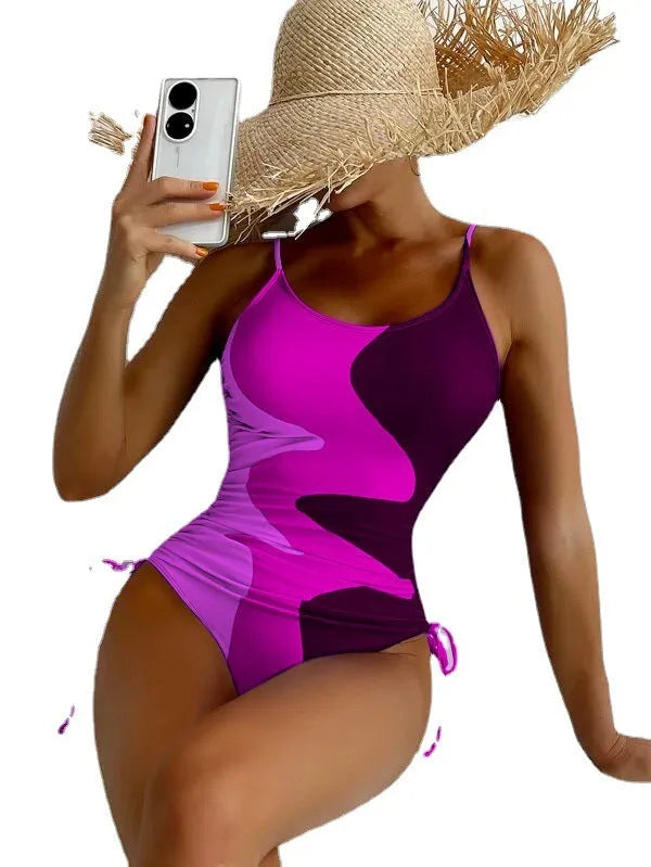 Women's sleeveless backless one-piece swimsuit in blue, shown in a solid colour style.