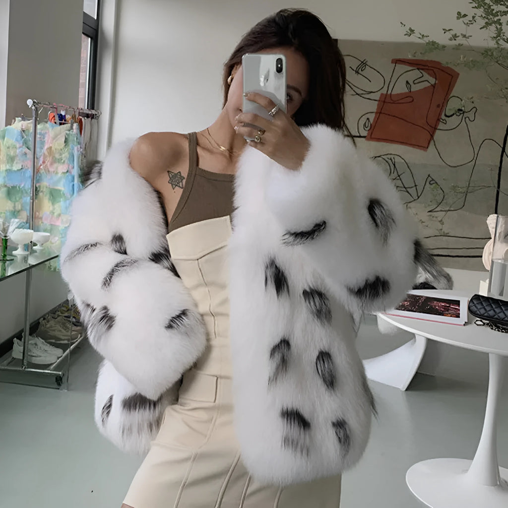 Black and white artificial raccoon fur coat with slim fit, short length, and regular sleeves on a model.