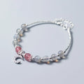 Simple handmade bracelet with round moonstone beads, a small crescent moon charm, and an adjustable metal clasp.