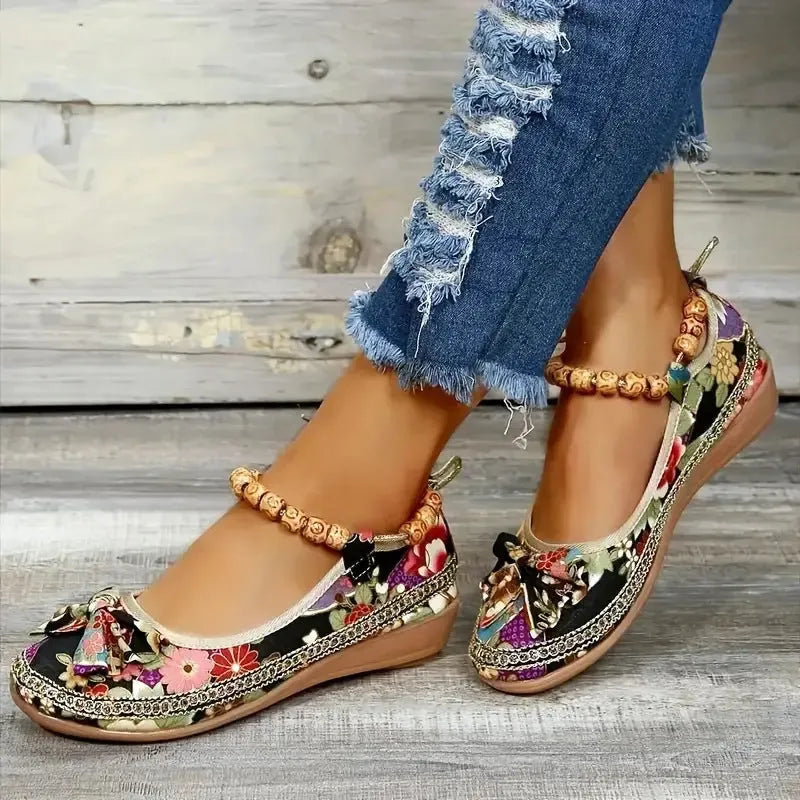 Women's ethnic platform sandals with elastic band closure in black colour showing cloth upper and round toe design