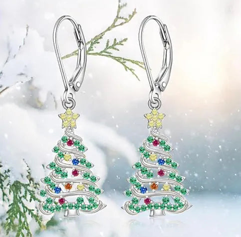 A pair of star-shaped copper earrings with a Christmas tree design, plated in a white gold colour.