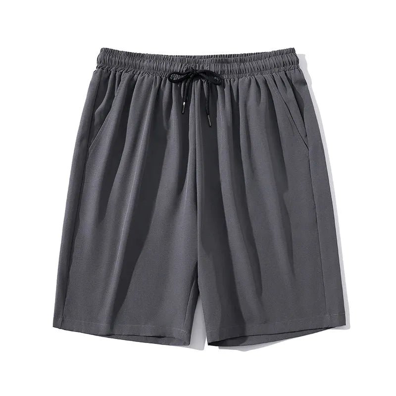 Man wearing grey cropped straight-leg casual sports pants made from quick-dry nylon fabric.