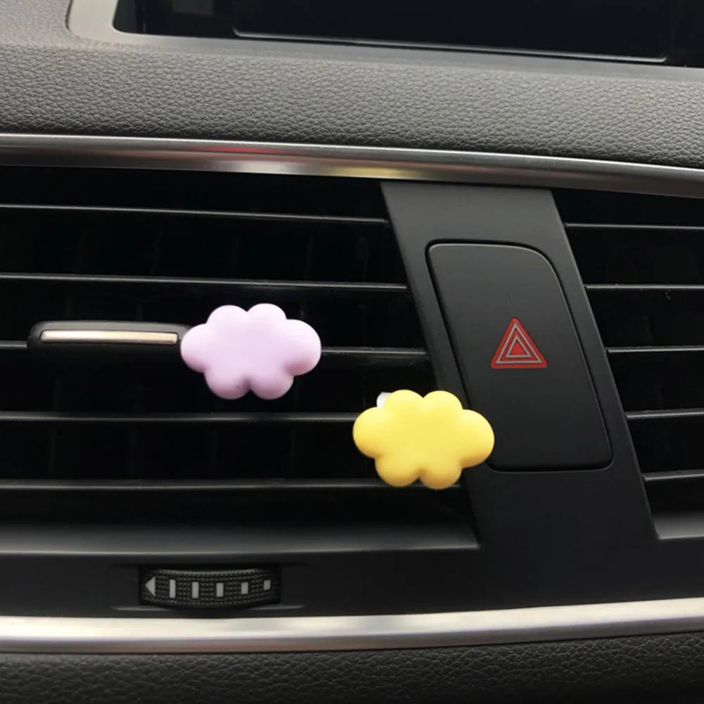Baiyun cartoon car fragrance clip in resin, shown in various colours for air vent mounting.