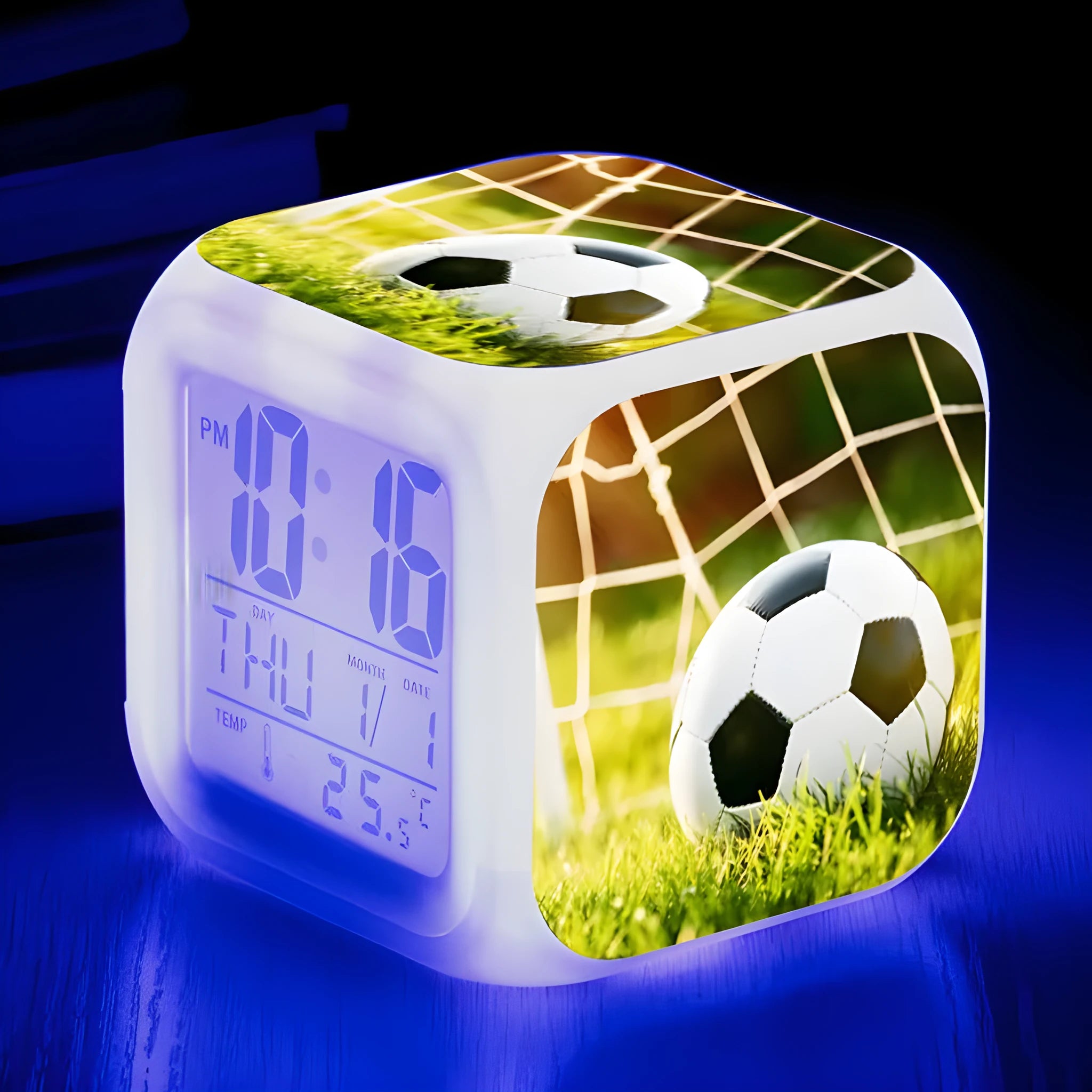 Square plastic alarm clock with football pattern design showing four alarm settings and USB charging port