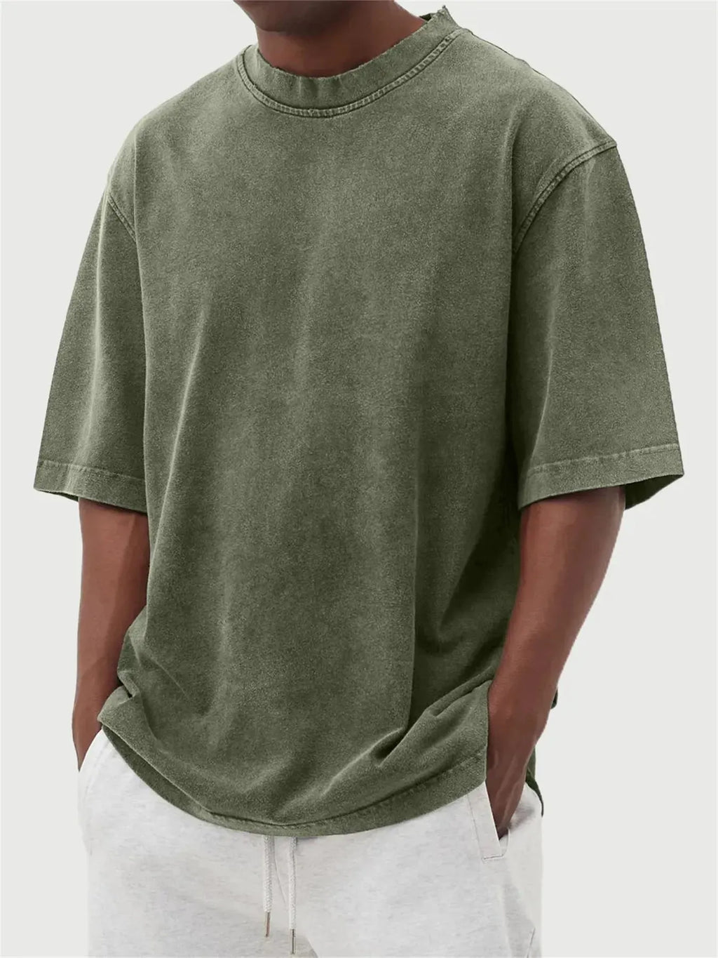 Men's loose-fit stone-washed t-shirt in army green showing distressed texture and pullover style.