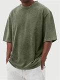 Men's loose-fit stone-washed t-shirt in army green showing distressed texture and pullover style.