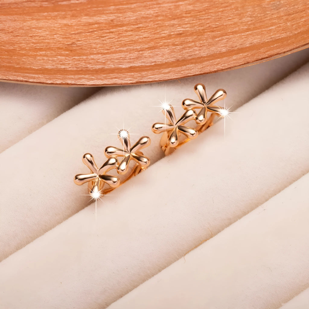 Circular rose gold electroplated earrings with a waterdrop floral design