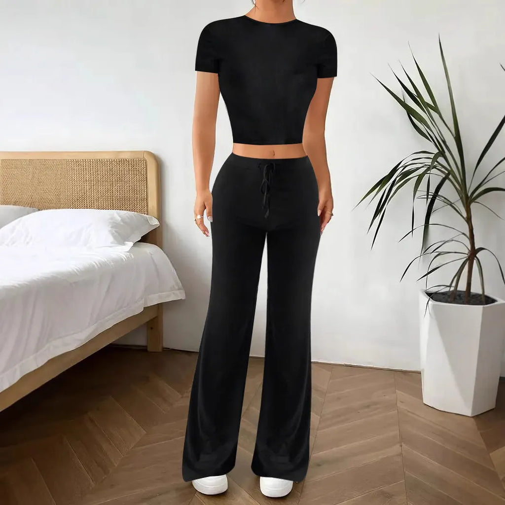 Women's black high waist trousers and short sleeve T-shirt suit set on a hanger