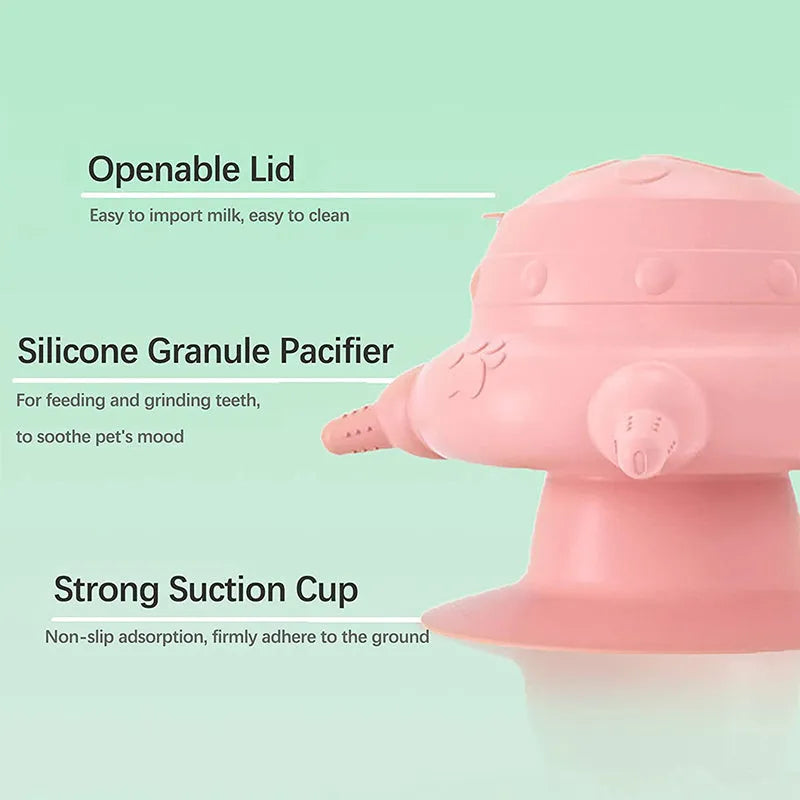 Pink silicone pet nursing milk bowl with four attached pacifiers on a flat base.