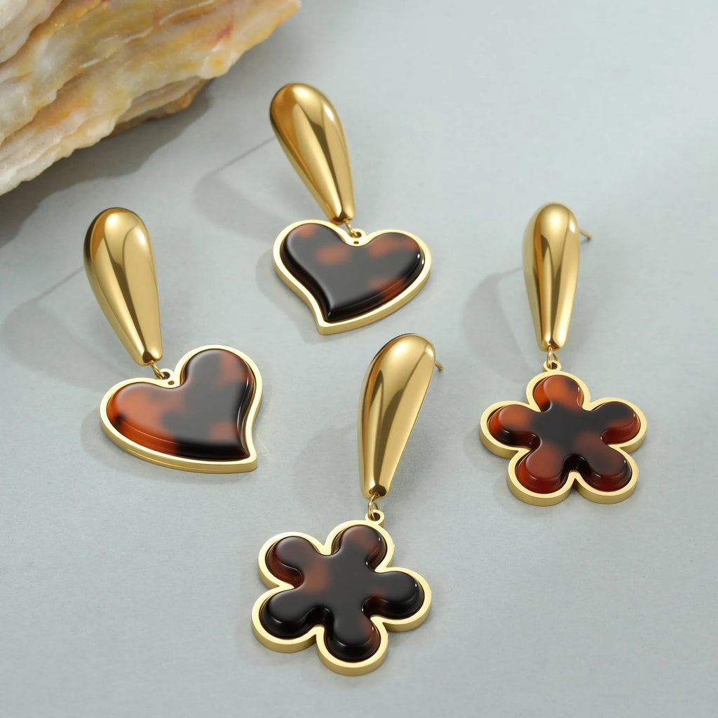 Gold electroplated tortoiseshell resin earrings in heart and geometric floral designs for women.