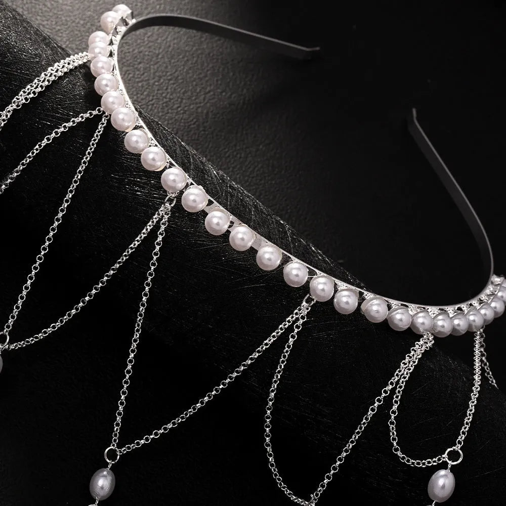 Close-up of a gold mesh hair chain with pearls and a tassel detail for women.
