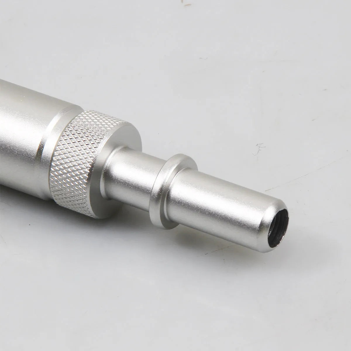 Silver metal VAS6262-9 transmission refueling joint adapter tool on a workshop bench